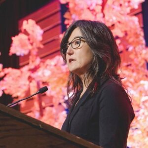 Brenda Choresi Carter speaking at a lectern.